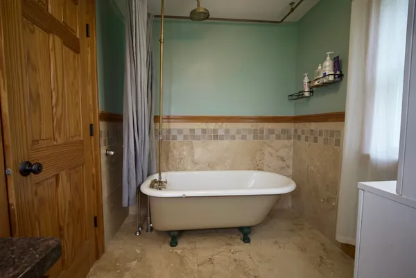 a bathroom with a tub and shower