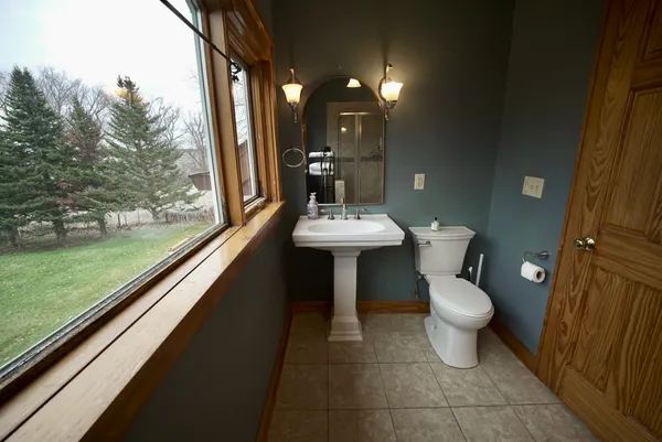 a bathroom with a toilet sink and mirror