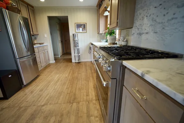 a kitchen with sink a refrigerator and a stove