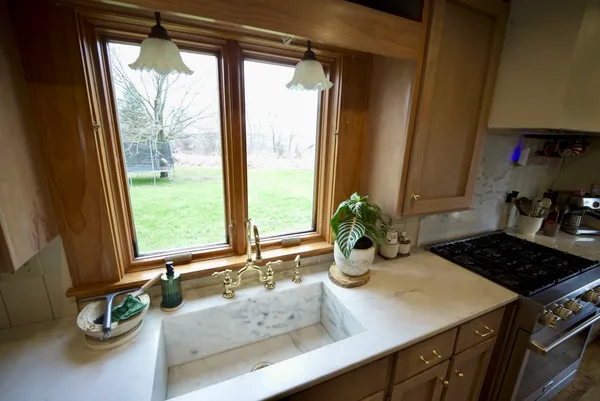 a kitchen with a large window and a stove