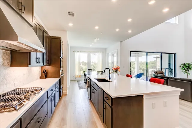 a kitchen with counter top space a sink a stove and a refrigerator