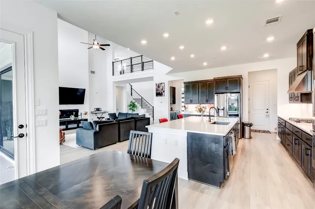 a living room with stainless steel appliances kitchen island granite countertop furniture a kitchen view and living room view
