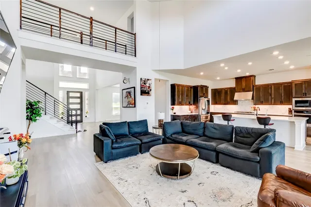 a living room with furniture and a view of kitchen