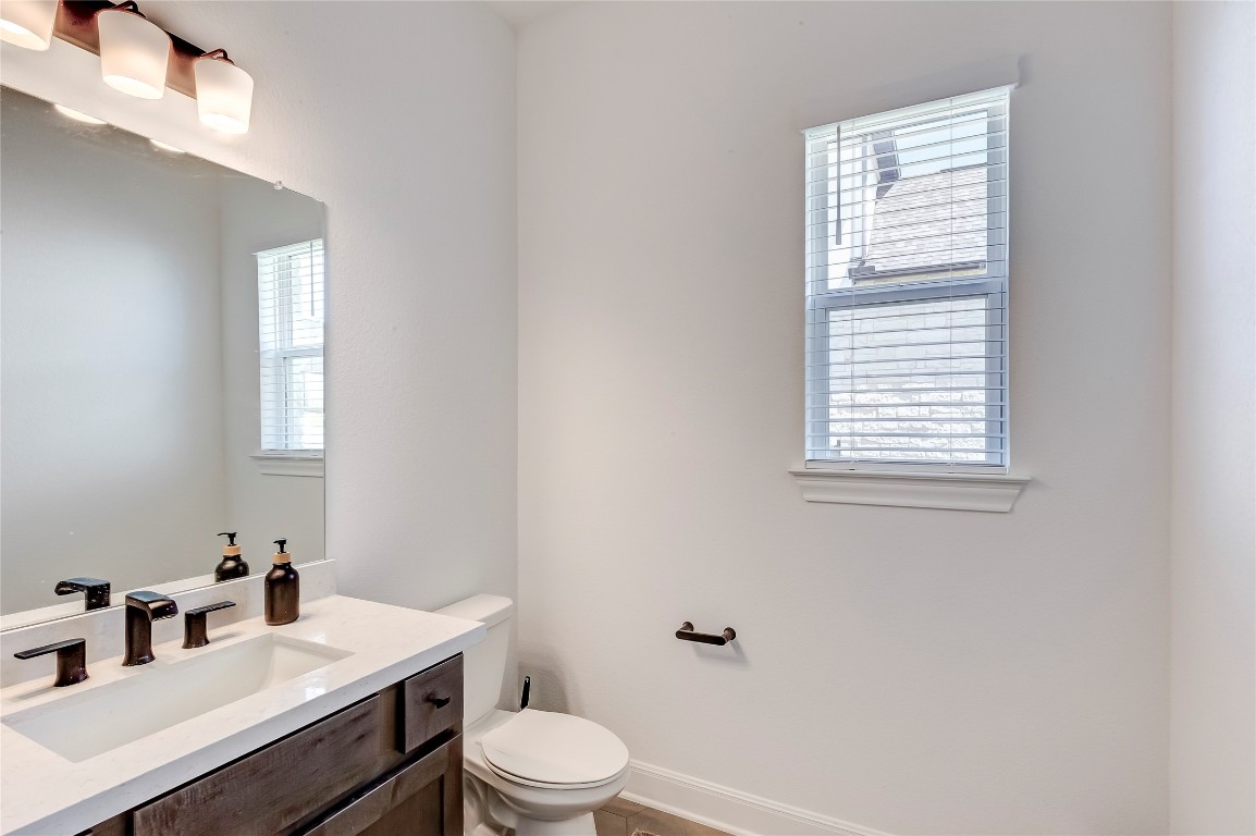 462 Old Stone Road Austin, TX 78737 - Photo 22 of 39 a bathroom with a sink a toilet and a window
