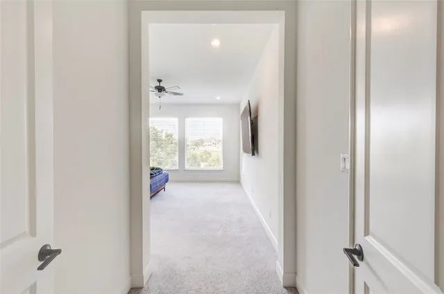 a living room with furniture and a ceiling fan
