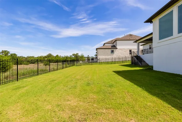 a view of a swimming pool and lounge chairs in the patio