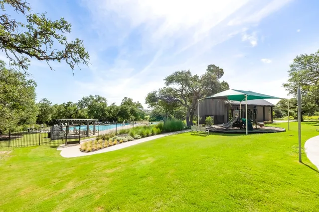 a view of a swimming pool with outdoor seating and a garden