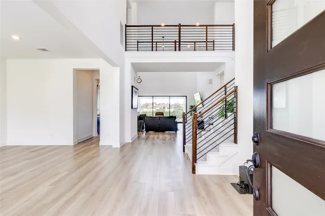 a view of entryway and hall with wooden floor