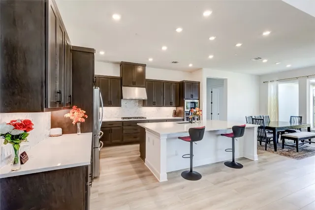 a living room with stainless steel appliances kitchen island granite countertop furniture and a kitchen view