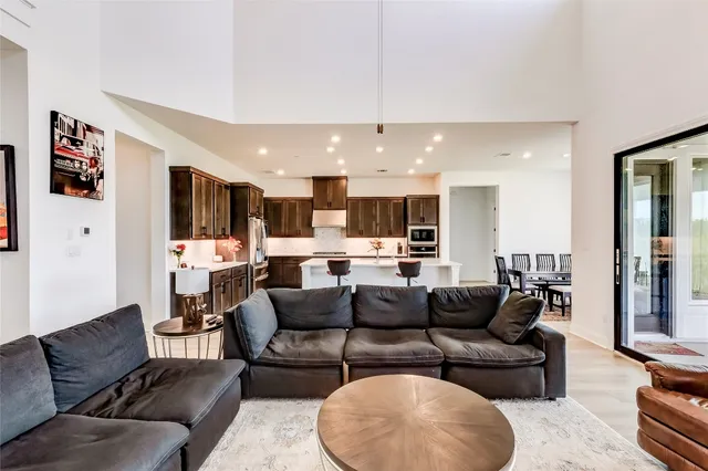 a living room with furniture and kitchen view