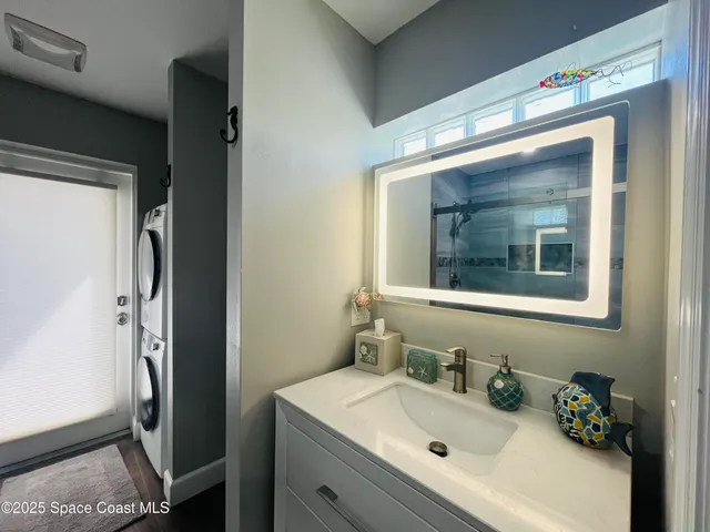 a bathroom with a sink vanity and mirror