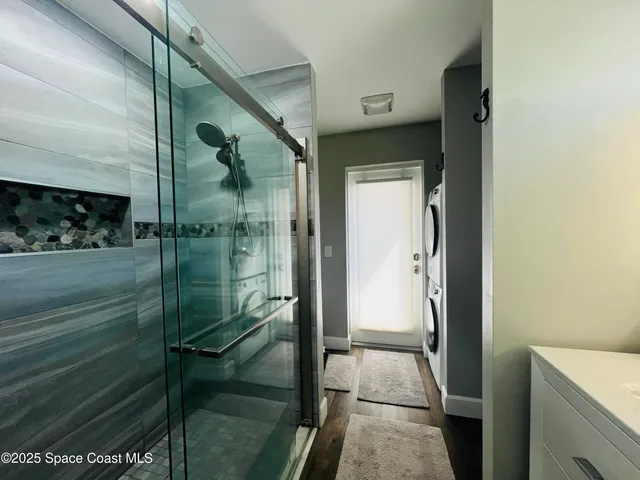 a bathroom with a glass shower door
