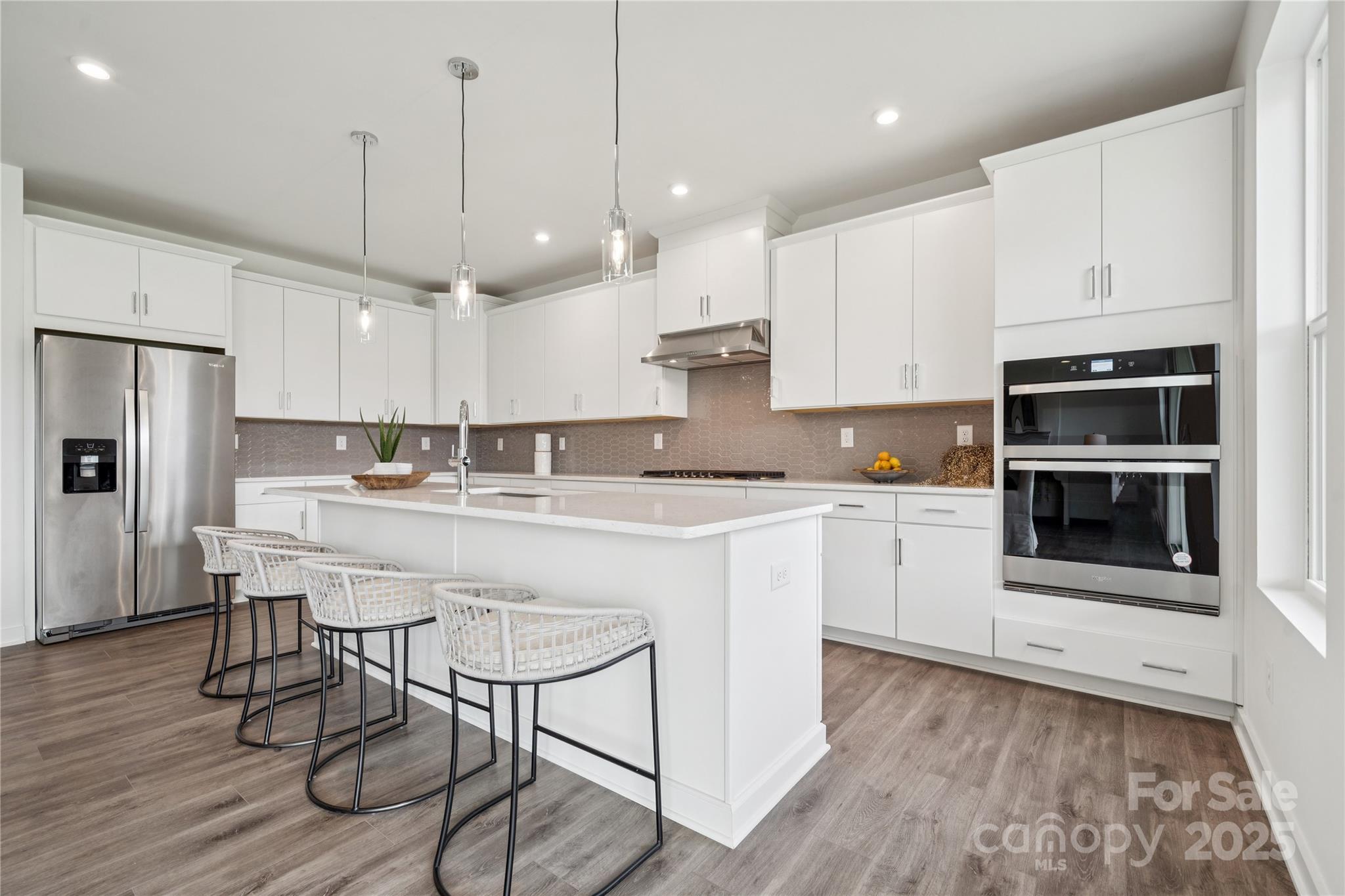 5348 Vernon Rdg Road, Unit 111 Huntersville, NC 28078 - Photo 6 of 14 a kitchen with stainless steel appliances granite countertop a white cabinets and wooden floors