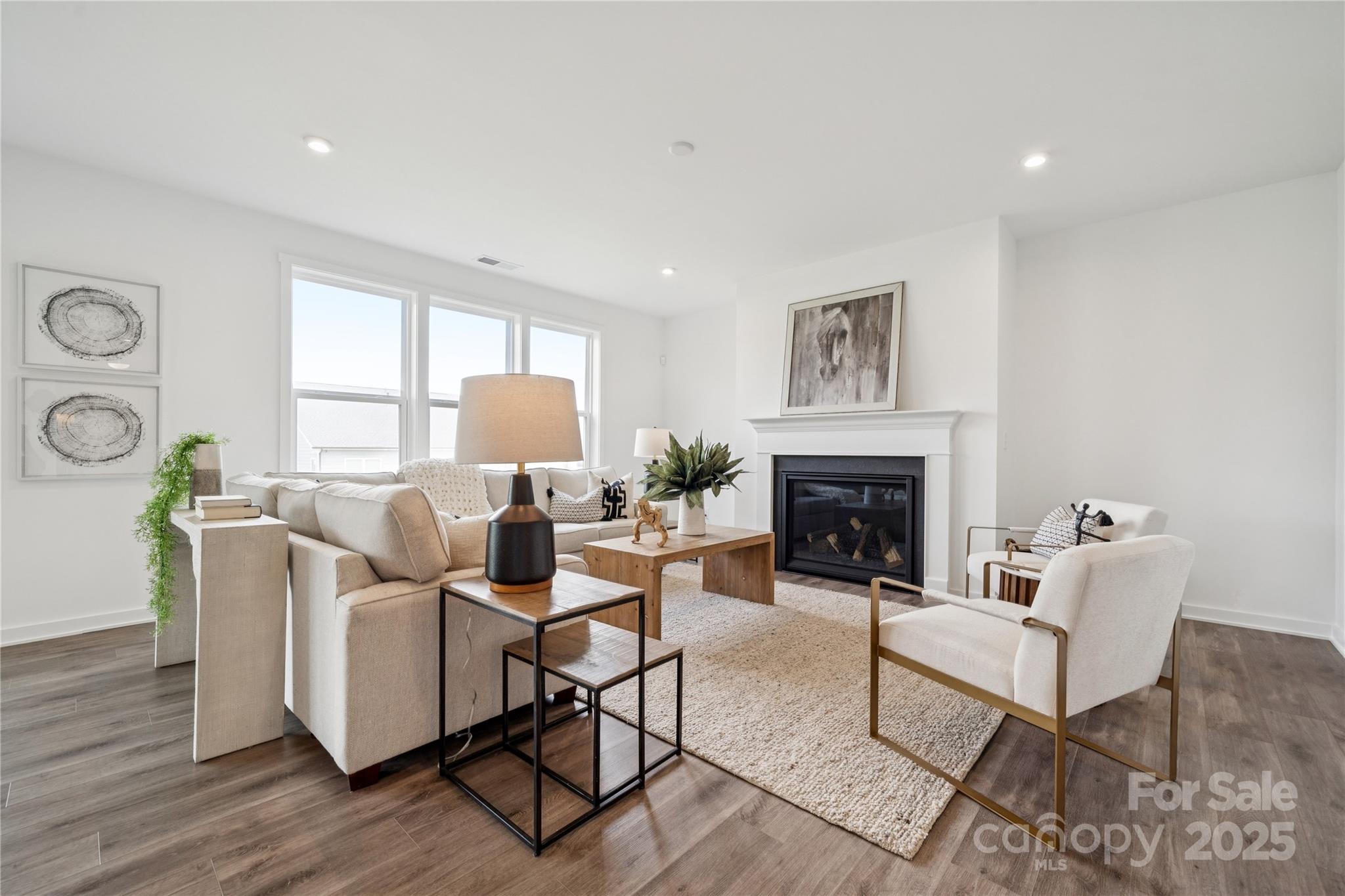 5348 Vernon Rdg Road, Unit 111 Huntersville, NC 28078 - Photo 8 of 14 a living room with furniture a fireplace and a large window