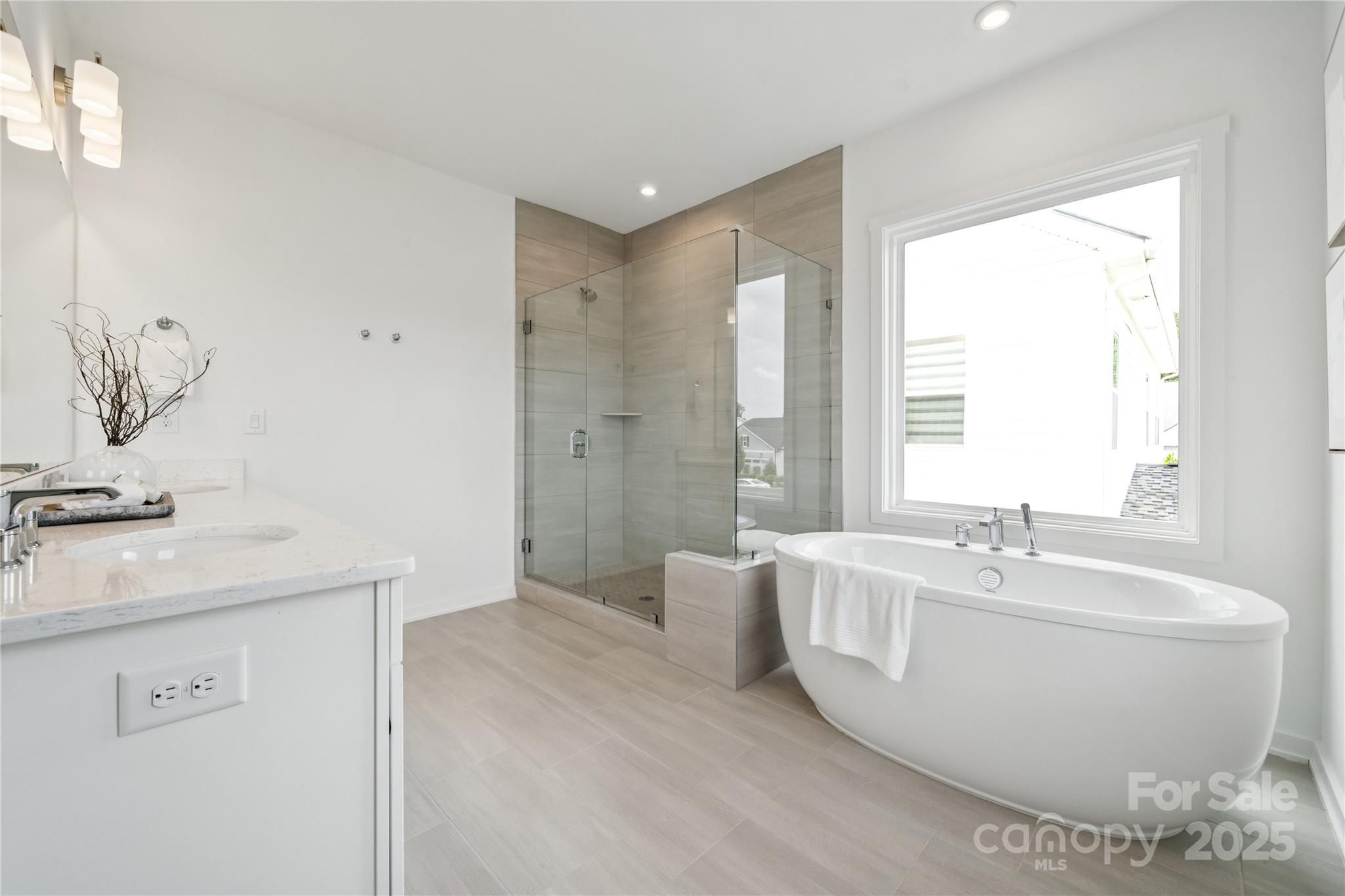 5348 Vernon Rdg Road, Unit 111 Huntersville, NC 28078 - Photo 10 of 14 a spacious bathroom with a bathtub sink and mirror