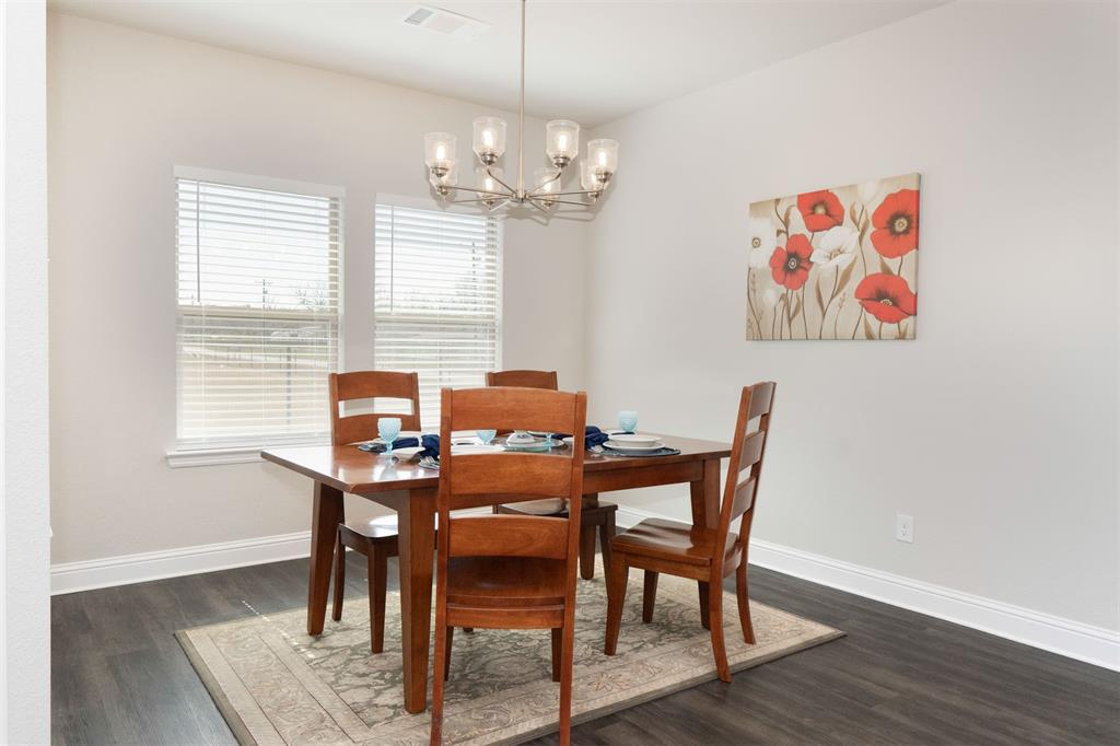 849 County Road 4764 Boyd, TX 76023 - Photo 15 of 40 a view of a dining room with furniture a chandelier and wooden floor
