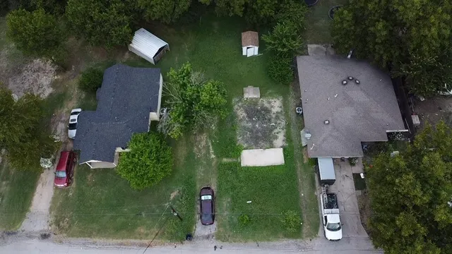 an aerial view of a house with outdoor space and street view