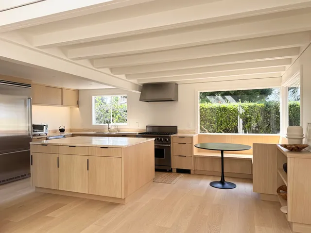 a kitchen with a stove a sink and a refrigerator