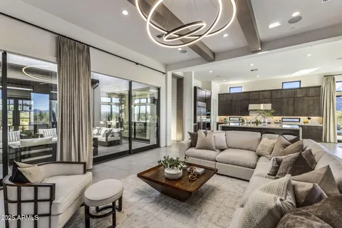 a dining room with furniture large windows and a rug