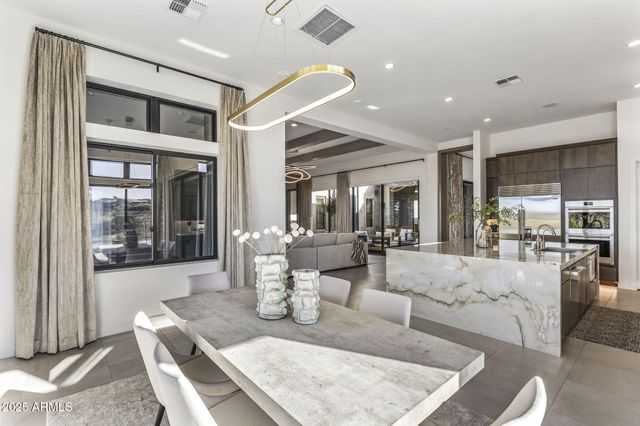 a spacious bathroom with a double vanity sink toilet mirror and bathtub