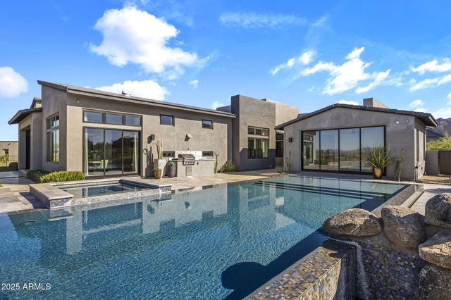 a view of a stone house with a small yard