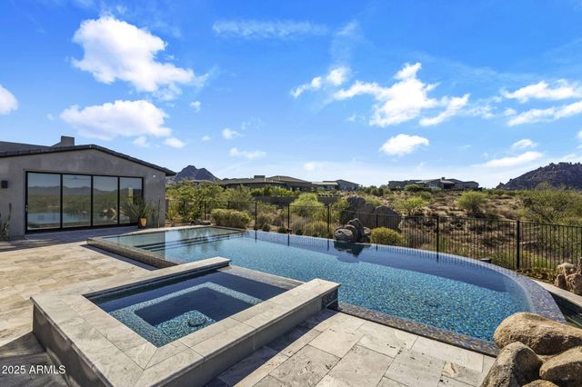 a view of a patio with table and chairs under an umbrella