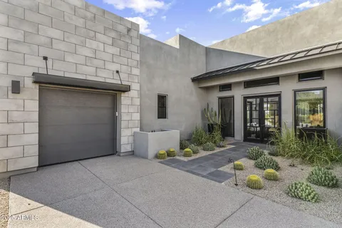 a view of a terrace with furniture and a garden