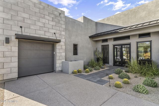 a view of a terrace with furniture and a garden