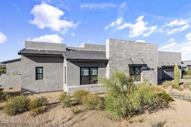 a front view of a house with swimming pool having outdoor seating