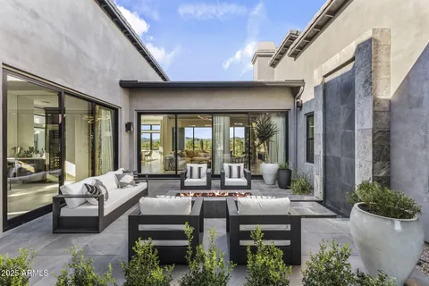 a living room with furniture a large window and a flat screen tv