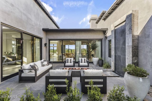 a living room with furniture a large window and a flat screen tv