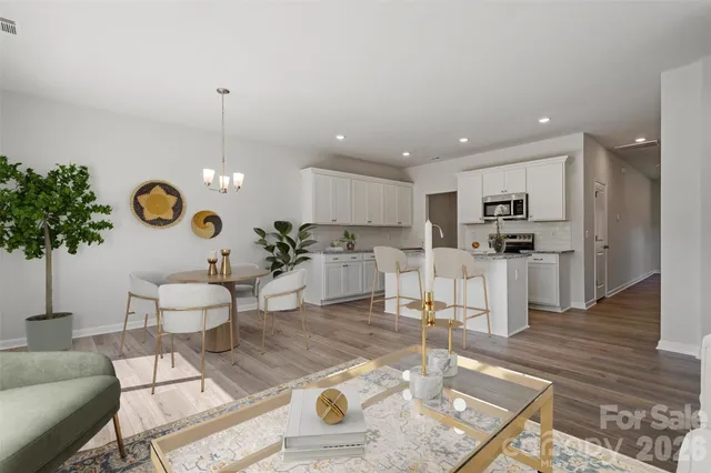 a living room with furniture and kitchen view