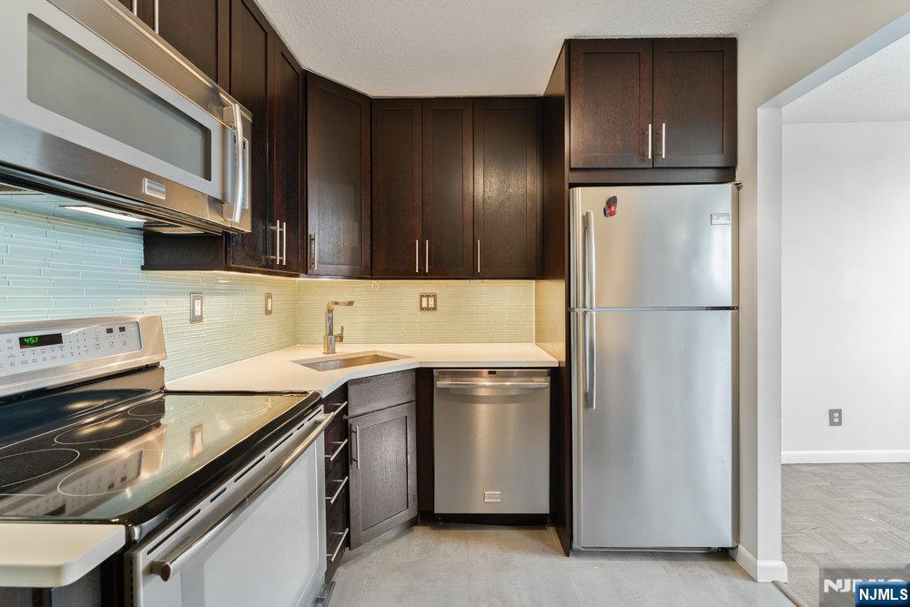 160 Overlook Avenue, Unit 20D Hackensack, NJ 07601 - Photo 9 of 22 a kitchen with a refrigerator and a sink