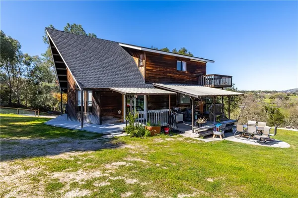 a view of a house with backyard porch and sitting area