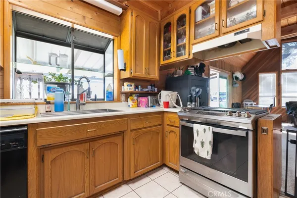 a kitchen with stainless steel appliances granite countertop a stove and a sink