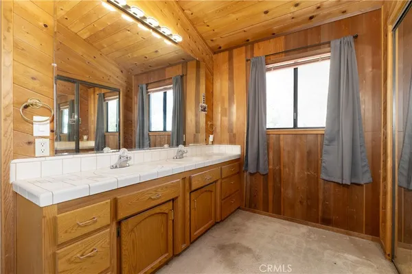 a bathroom with a granite countertop sink mirror and double