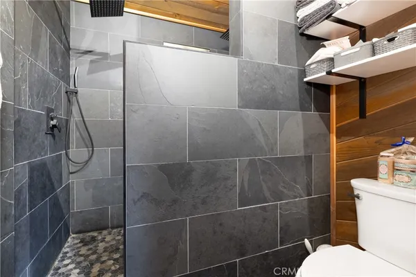 a bathroom with a toilet and a shower