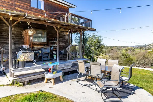 a view of a house with swimming pool and sitting area