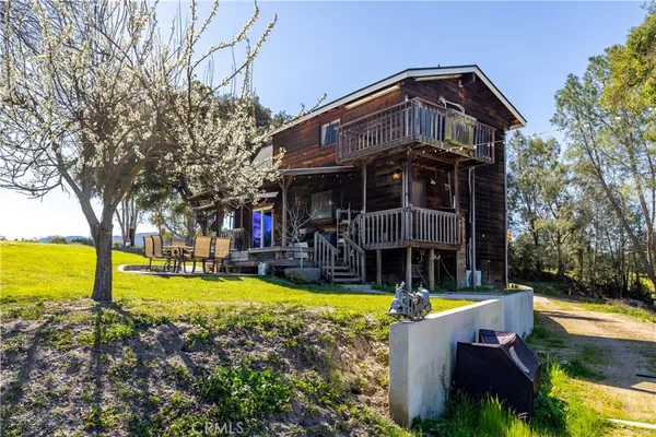 a view of a house with backyard and sitting area