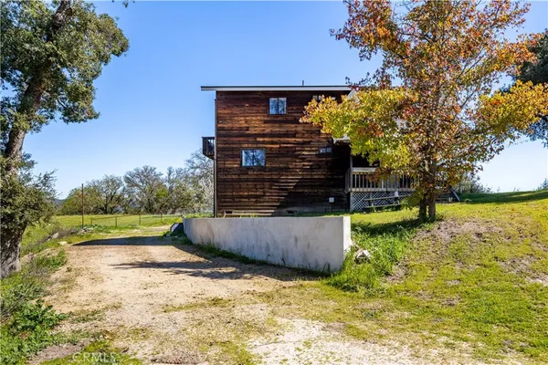 a view of yard with swimming pool and trees in the background