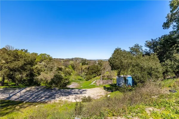 a view of a yard with wooden fence