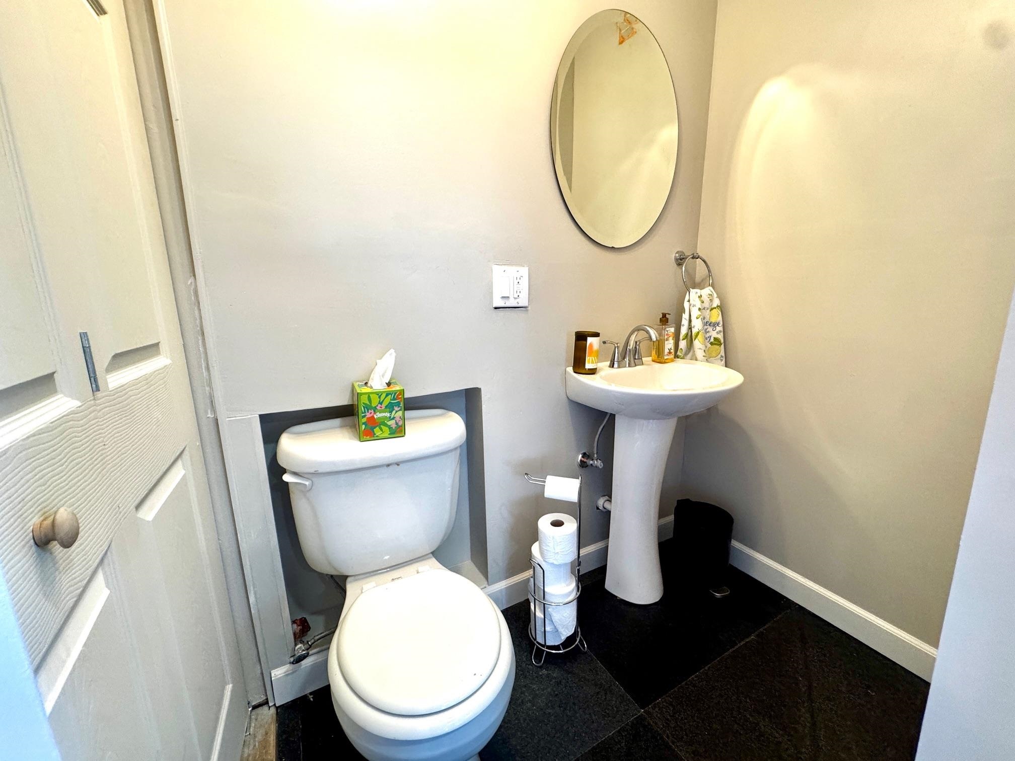6410 Gray Road Valley Spring, TX 76885 - Photo 11 of 31 a white toilet sitting next to a bathroom sink