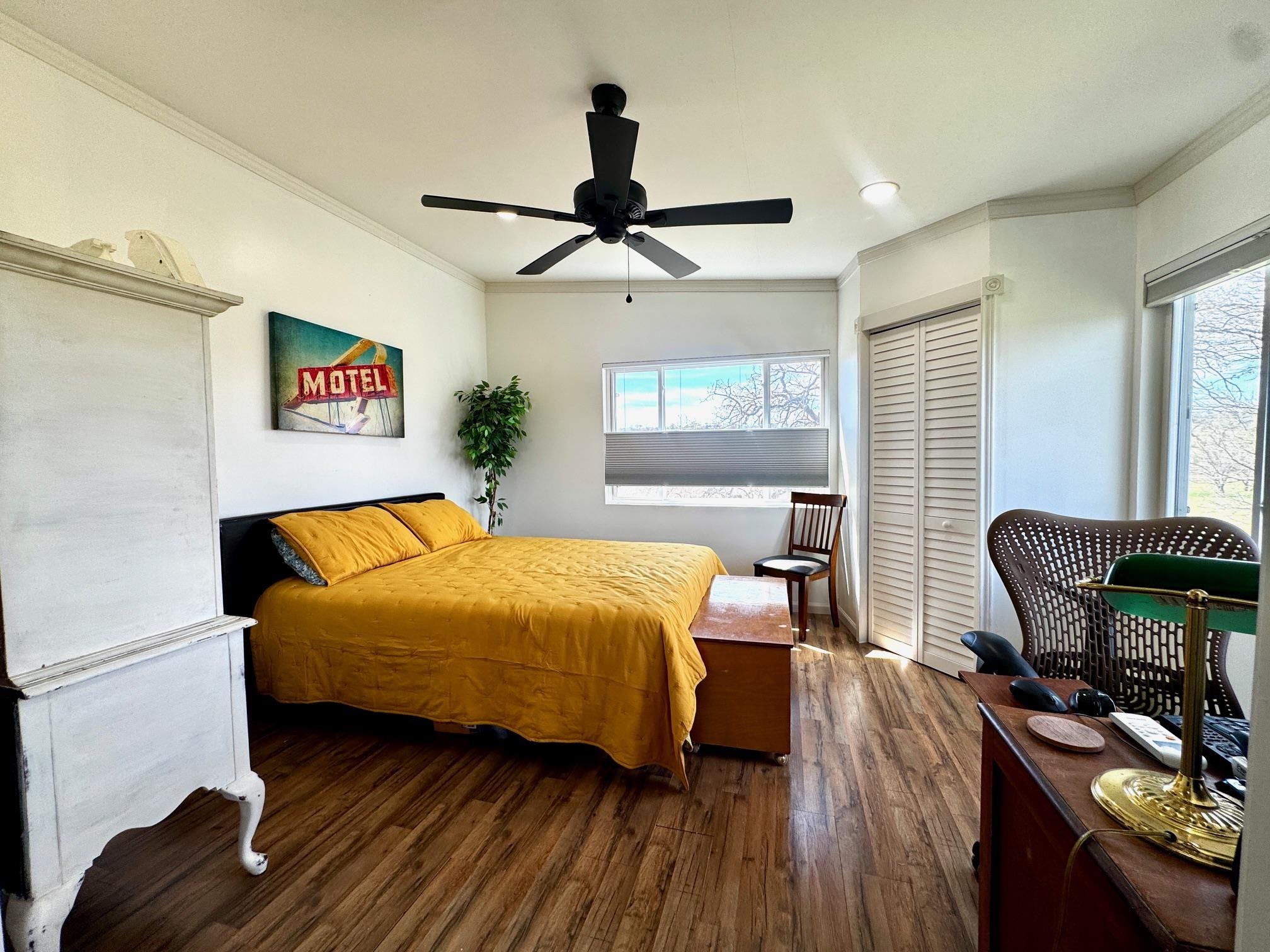 6410 Gray Road Valley Spring, TX 76885 - Photo 14 of 31 a bedroom with a bed and wooden floor