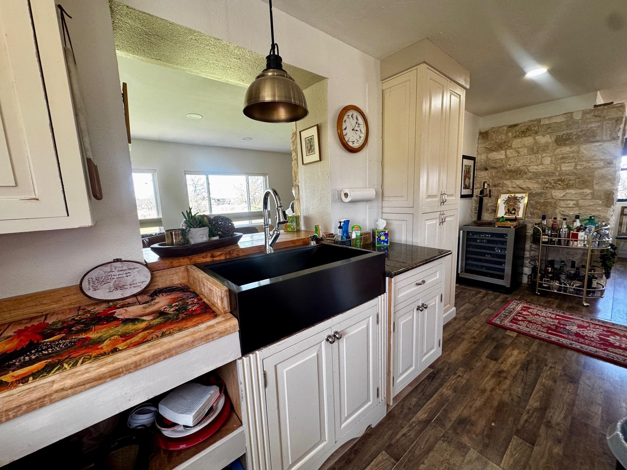 6410 Gray Road Valley Spring, TX 76885 - Photo 7 of 31 a kitchen with a stove and a wooden floor