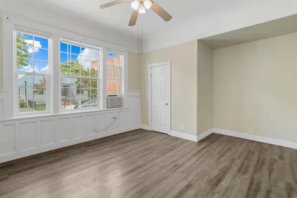 a view of an empty room with wooden floor