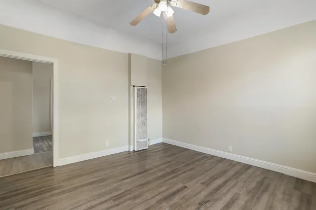 a hallway with stairs and wooden cabinet