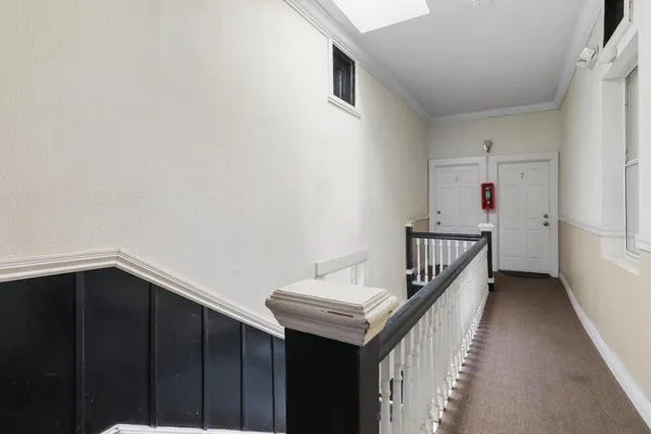 a view of a hallway with wooden floor
