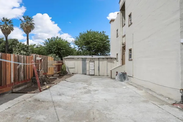 a view of a hallway with stairs and wooden floor