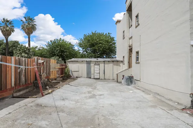a view of a hallway with stairs and wooden floor