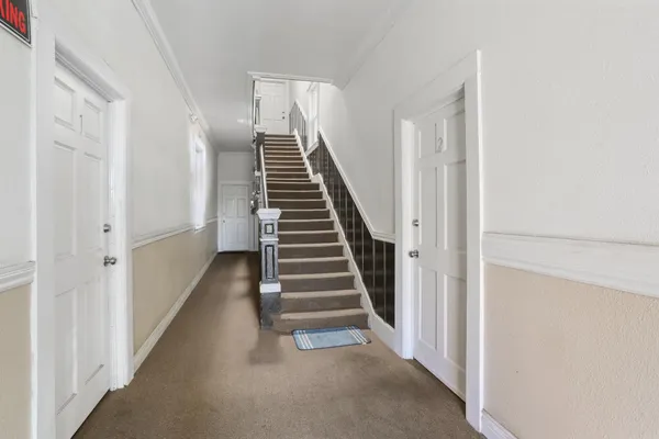 a view of backyard with wooden fence and trees
